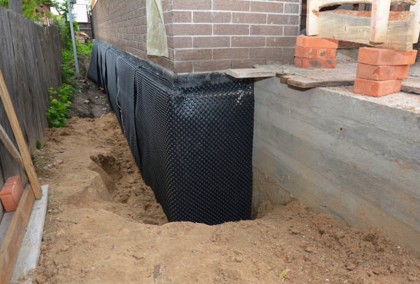 Happy homeowners after waterproofing job in Arcade